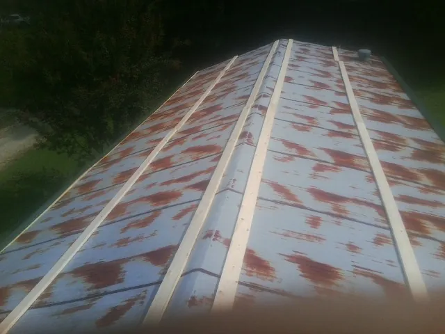 Rusted metal roof panels with new wood purlins before replacement — Storm Damage Roof Repair in Idyllwild by Roofing Brothers