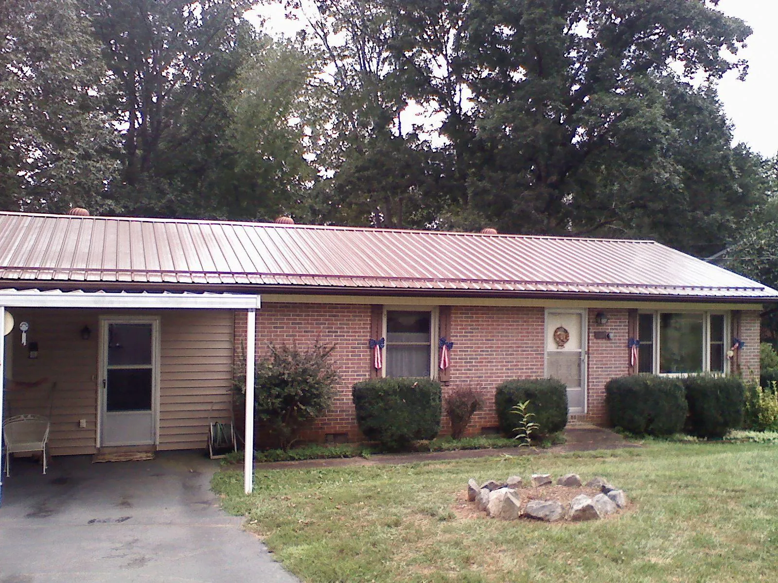Bronze metal roof and carport on a brick ranch home — Roof Repair work by our crew in Idyllwild